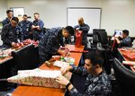 Sailors, assigned to Commander Submarine Group 7, wrap gifts intended for less fortunate children in Yokohama, Japan. The Submarine Group 7 First Class Petty Officer Association participated in a holiday gift drive for 64 underprivileged children in the Yokohama area.