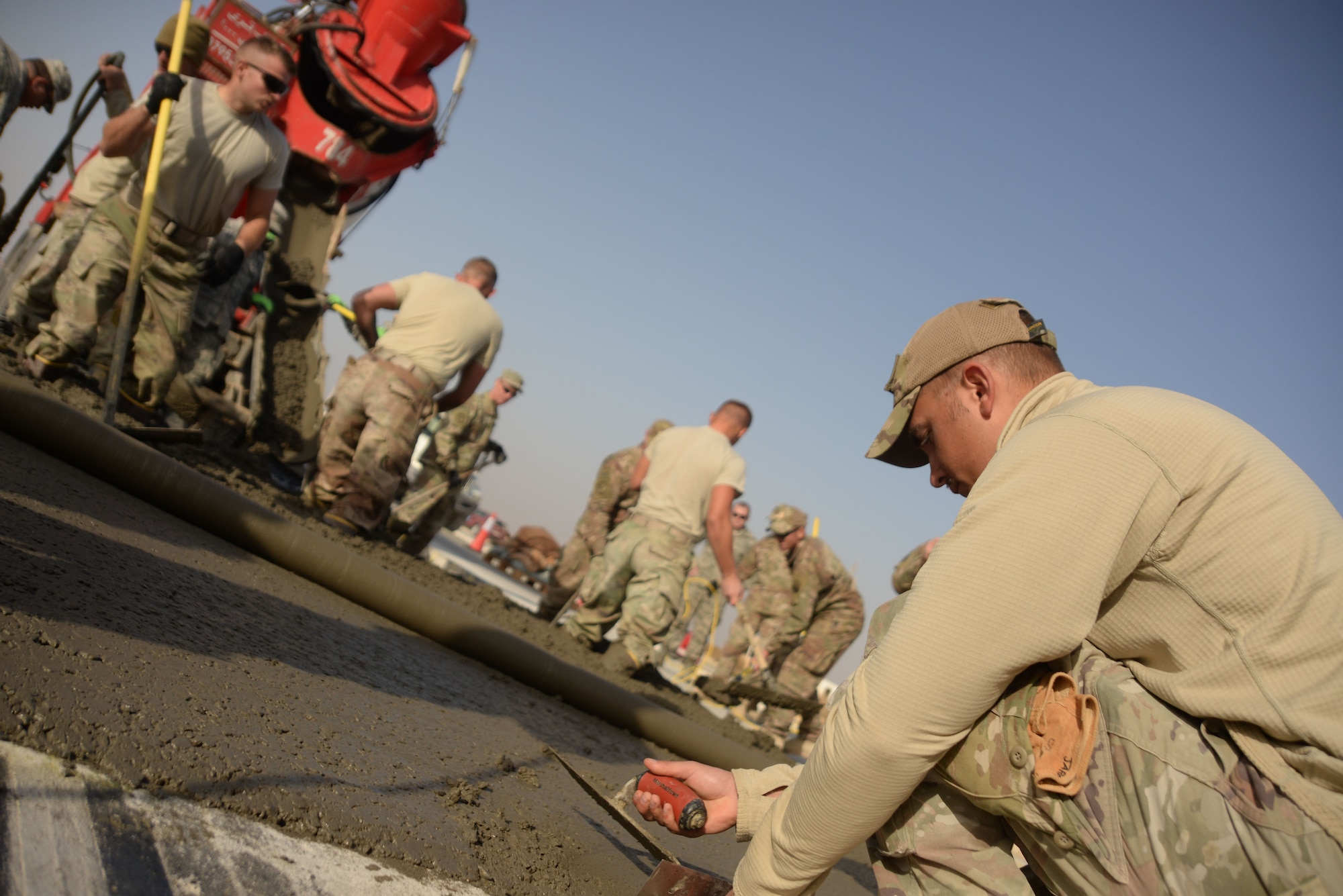 Staff Sgt. Jared Hendrickson, a heavy equipment operator assigned to the 332nd Civil Engineer Squadron, smooths out a concrete slab at an undisclosed loaction in Southwest Asia Nov. 28, 2017. One of the primary jobs of a Dirt Boy is to keep the runway safe and reliable through runway repair. Hendrickson and other members of the team work around the clock to ensure U.S. and Coalition forces are able to take off and land on this busy runway. (U.S. Air Force photo by Senior Master Sgt. Cohen A. Young)