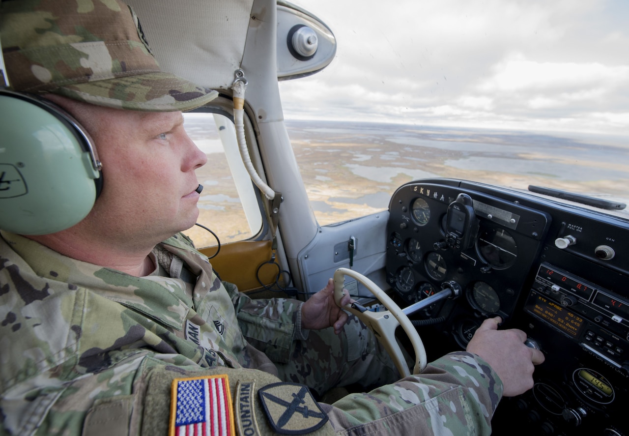 A soldier flies his small airplane to a recruiting visit