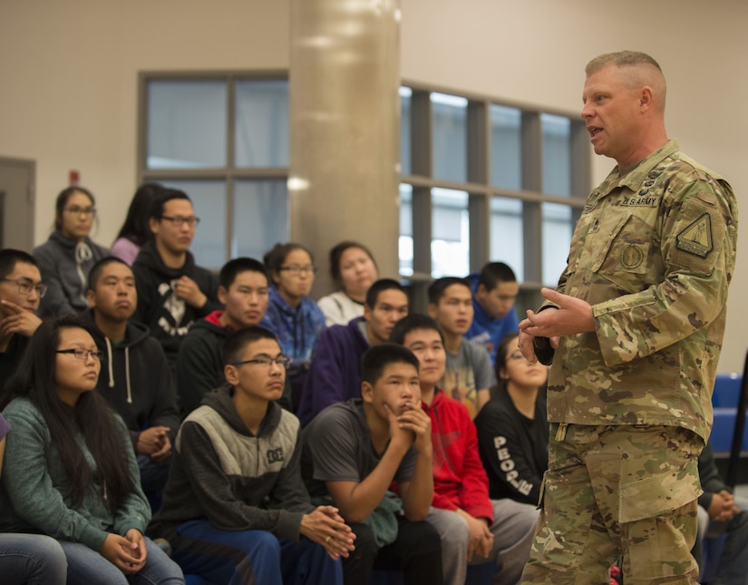A soldier speaks to high school students during a recruiting visit