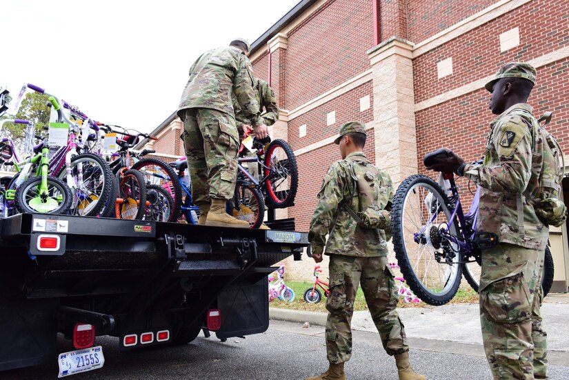 U.S. Army Soldiers assigned to the 128th Aviation Brigade load bicycles onto a truck in support of the U.S. Marine Corps’ Toys for Tots program at Joint Base Langley-Eustis, Va., Dec. 6, 2017.