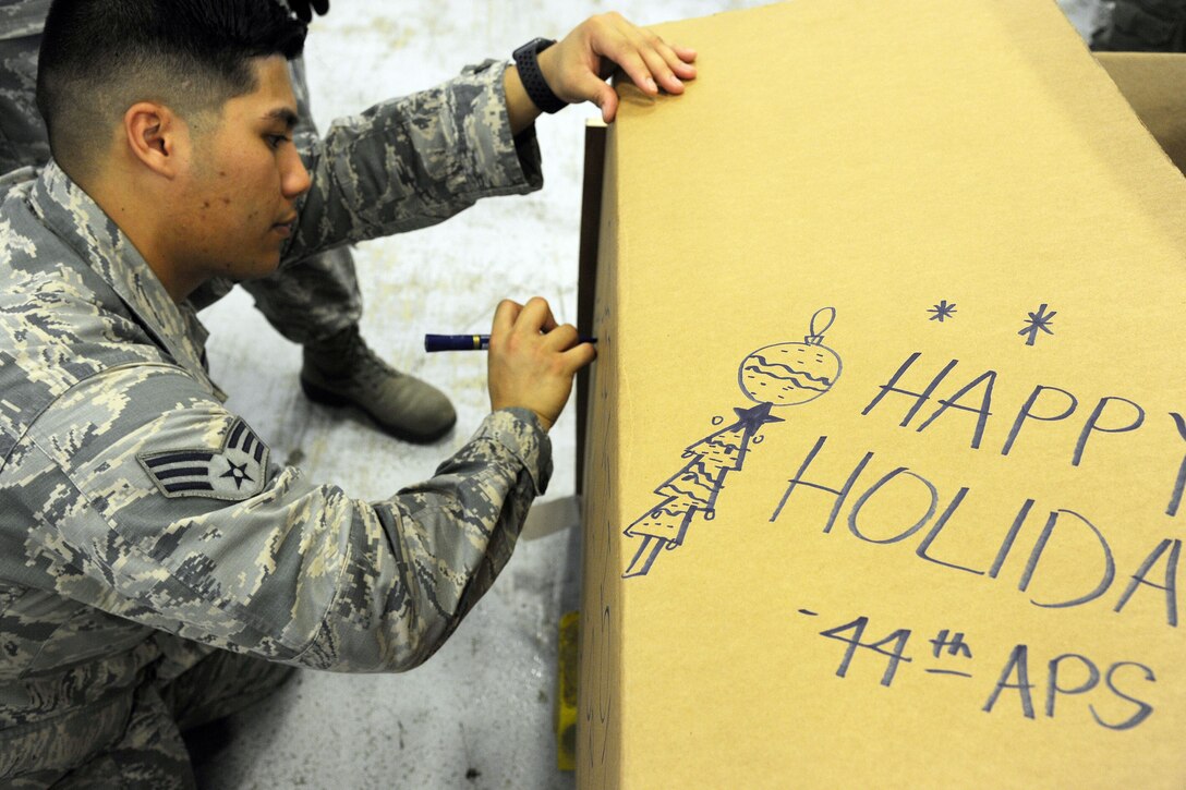 Airman add a special message to a package.