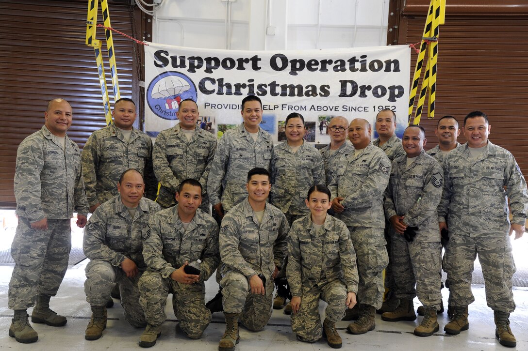 Air Force Reserve Airmen post for a picture at the end of Operation Christmas Drop