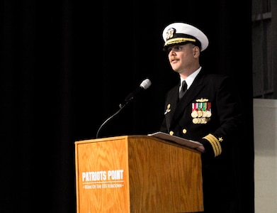 U.S. Navy Cmdr. Carl Brobst, gives a speech after assuming command of the Naval Consolidated Brig Charleston from his predecessor, Cmdr. Brett Pugsley, during a change of command ceremony Dec. 8, 2017 onboard the USS Yorktown, Mount Pleasant, S.C.