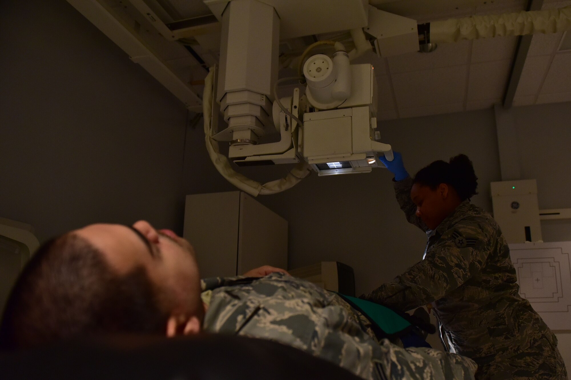 Senior Airman Akilah Hall, 19th Medical Support Squadron diagnostic imaging technologist, performs an X-ray on a patient Dec. 5, 2017, at Little Rock Air Force Base, Ark. The X-ray tube is maneuverable enough to capture X-rays of patients sitting and lying down. (U.S. Air Force photo by Airman 1st Class Rhett Isbell)