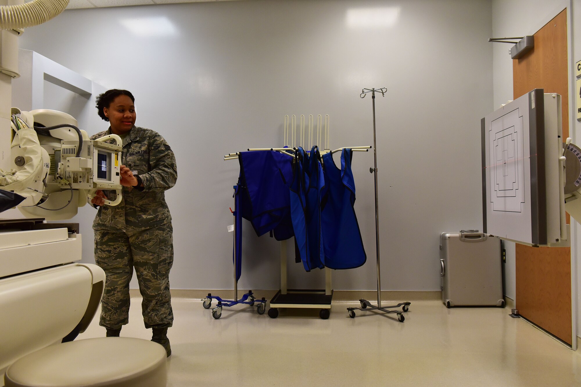 Senior Airman Akilah Hall, 19th Medical Support Squadron diagnostic imaging technologist, aims an X-ray tube at a target Dec. 5, 2017, at Little Rock Air Force Base, Ark. The target allows for a standard and reference point for Hall, when she is taking x-rays. (U.S. Air Force photo by Airman 1st Class Rhett Isbell)