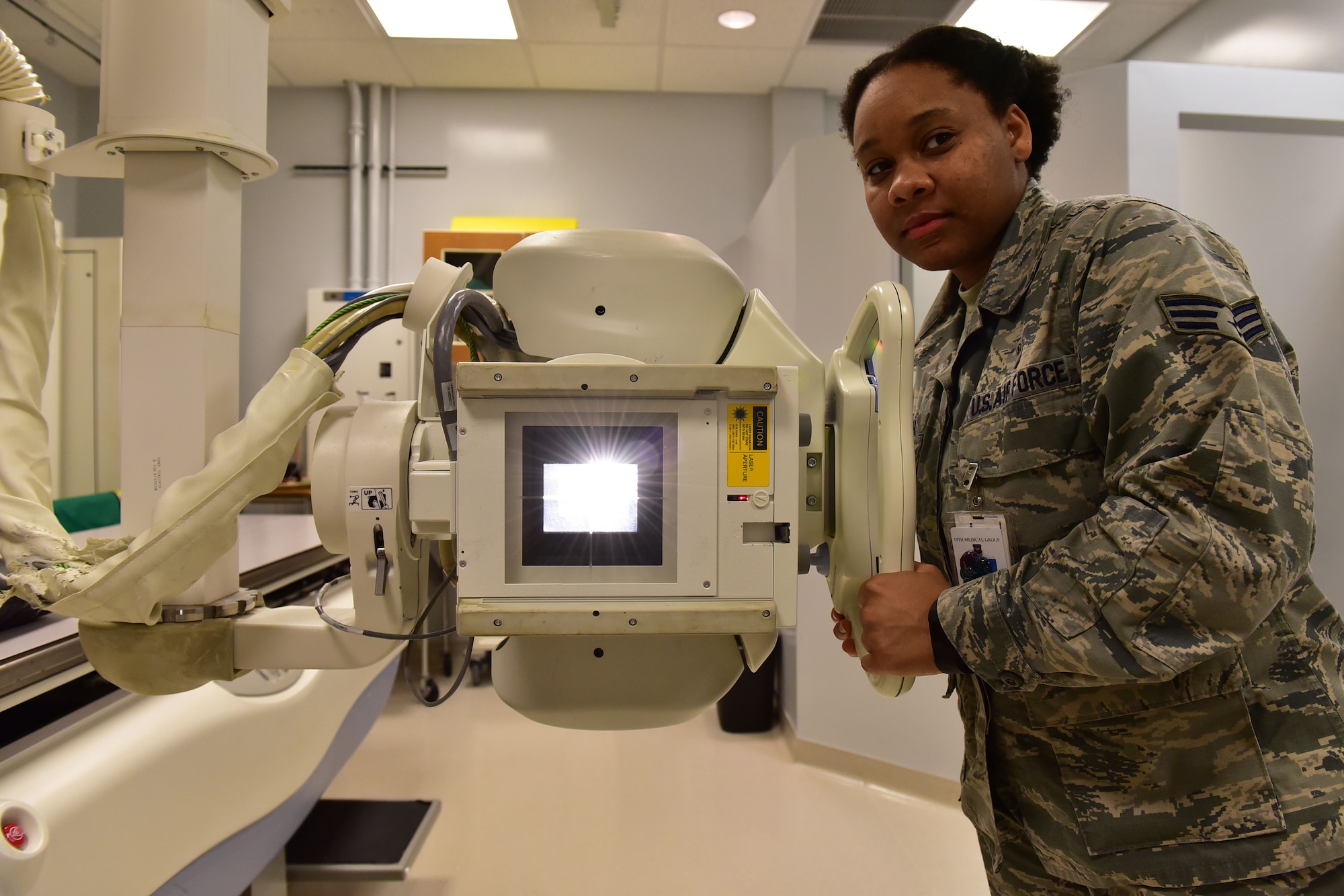 Senior Airman Akilah Hall, 19th Medical Support Squadron diagnostic imaging technologist, aims an X-ray tube at a target Dec. 8, 2017, at Little Rock Air Force Base, Ark.  The X-ray tube has to be warmed up and calibrated before it can be used. The proper exposure must also be found for specific parts of the body. (U.S. Air Force photo by Airman 1st Class Rhett Isbell)