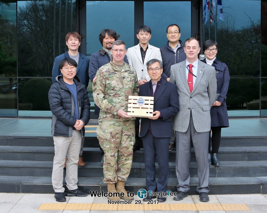 Left to right: Kim Yong Kuk; DLA Distribution Korea commander, Army Lt. Col Gary Whittacre; Pak, Byong Gil; Dave Harris; O, Hyon Yong. 2nd Row left to right: Kim, Tae Hyon; Kim, Yong Ki; Hwang, Chong Kyu;  Kim, Chol Won.
