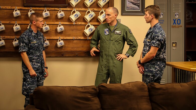 Maj. Patrick Bergman gives a tour of Marine Fighter Attack Training Squadron 501 to two Midshipman aboard Marine Corps Air Station Beaufort, Aug. 1. The Midshipman visited the air station as part of their summer cruise, to experience the aviation side of the Marine Corps. While aboard MCAS Beaufort, they visited Marine Aircraft Group 31, visited F/A-18 Hornet squadrons, VMFAT-501, and took a Marine Corps Martial Arts Program class. Bergman is a pilot with VMFAT-501.