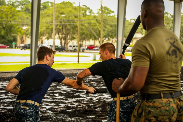 Midshipman Theo Freidenrich (left) and Midshipmen Austin Pitcher (right) practice Marine Corps Martial Arts Program techniques aboard Marine Corps Air Station Beaufort, Aug. 8. The Midshipmen visited the air station as part of their summer cruise, to experience the aviation side of the Marine Corps. While aboard MCAS Beaufort, they visited Marine Aircraft Group 31, visited F/A-18 Hornet squadrons, VMFAT-501, and took a MCMAP class.