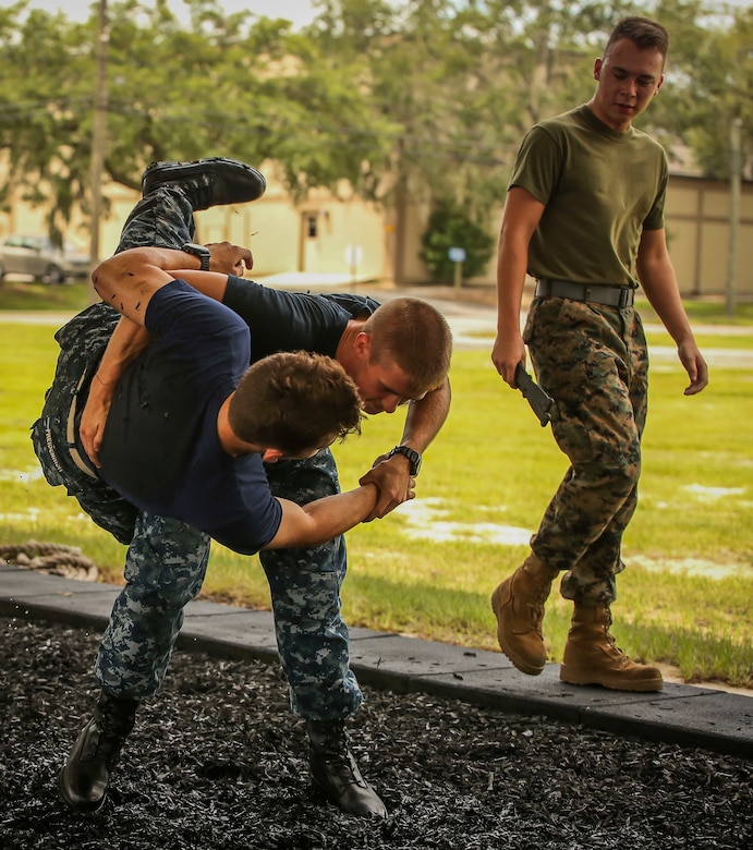 Midshipman Theo Freidenrich (left) and Midshipmen Austin Pitcher (right) practice Marine Corps Martial Arts Program techniques aboard Marine Corps Air Station Beaufort, Aug. 8. The Midshipmen visited the air station as part of their summer cruise, to experience the aviation side of the Marine Corps. While aboard MCAS Beaufort, they visited Marine Aircraft Group 31, visited F/A-18 Hornet squadrons, VMFAT-501, and took a MCMAP class.