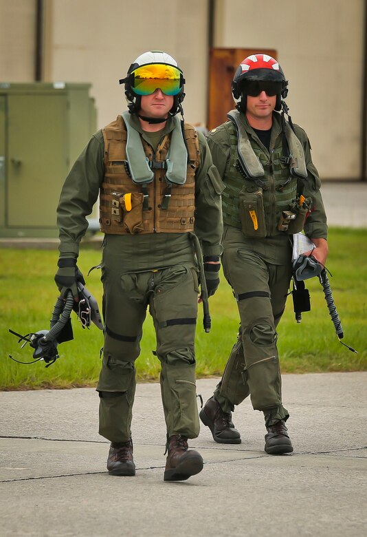 Two pilots walk to their F-5N Tiger II aboard Marine Corps Air Station Beaufort, Aug. 21. A detachment of Marine Fighter Training Squadron 401 will be aboard Fightertown from Aug. 20- Sept. 1 providing red air for Marine Fighter Attack Training Squadron 501. VMFT-401 will simulate an enemy for the warlords to fight and maneuver against. The pilot is with VMFT-401.