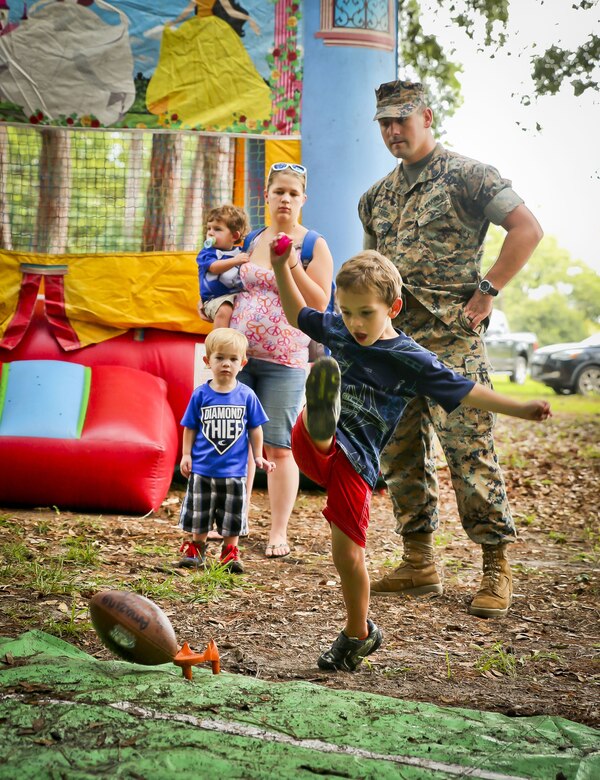 A boy kicks a football as part of a game during the 2017 Military Appreciation Day aboard Laurel Bay Housing, Aug. 26. The Beaufort Regional Chamber of Commerce hosted the event to thank service members and their families for contributions made to the Tri-command area. During the event, service members and their families could visit sponsored booths, play games, and enjoy free food.