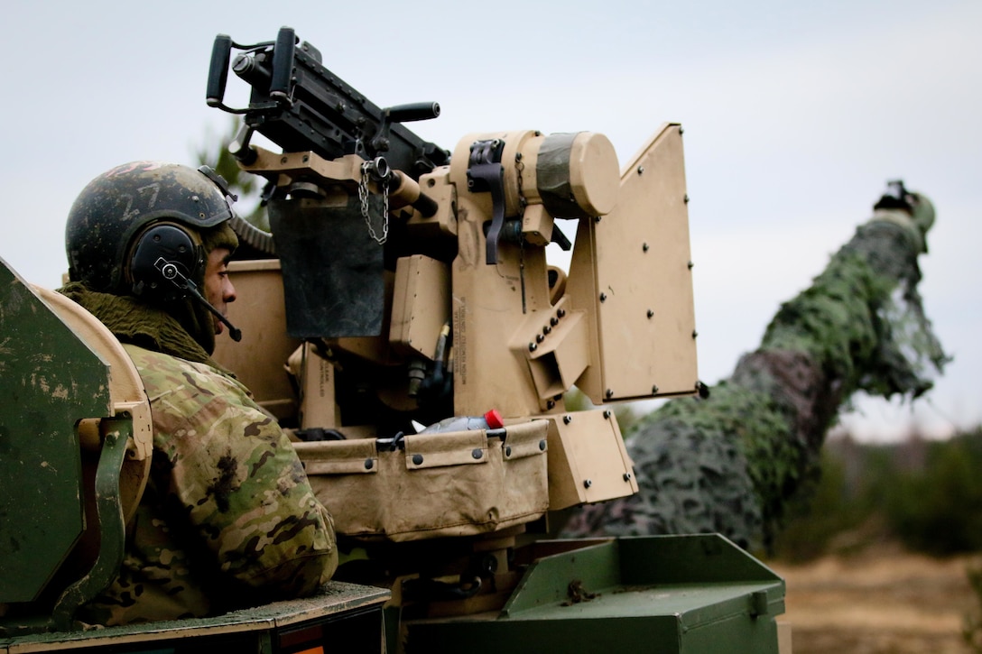 A soldiers helps prepare a Abrams tank during training