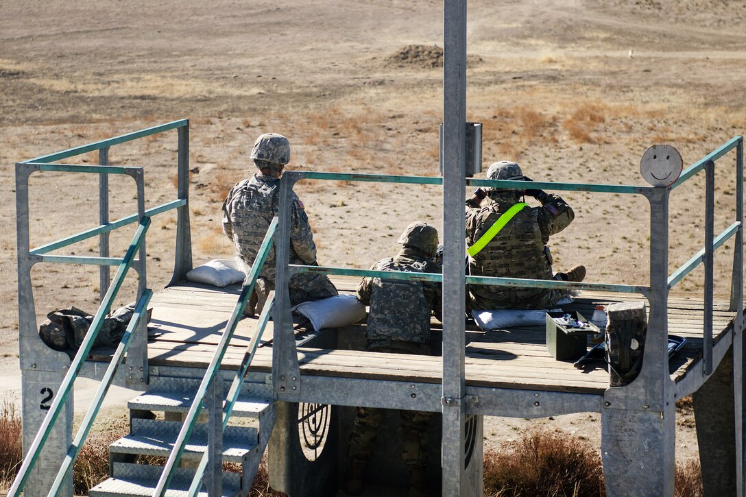 Soldiers observe team members qualifying with the M240B machine gun.