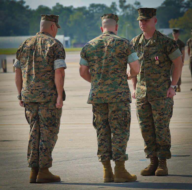 Lt. Col. Michael P. Brennan is awarded the Meritorious Service Medal during a Relinquishment of Command Ceremony aboard Marine Corps Air Station Beaufort, Sept. 22. During the ceremony, Brennan relinquished command of “The Flying Leathernecks” and then cased the squadron colors for transport. The squadron will stand up aboard Marine Corps Air Station Yuma, Ariz. as an F-35B Lightning II Joint Strike Fighter squadron.