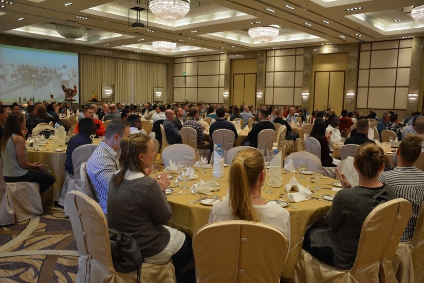 People sitting at tables in a banquet hall.
