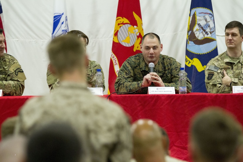 Soldiers on stage answer questions.