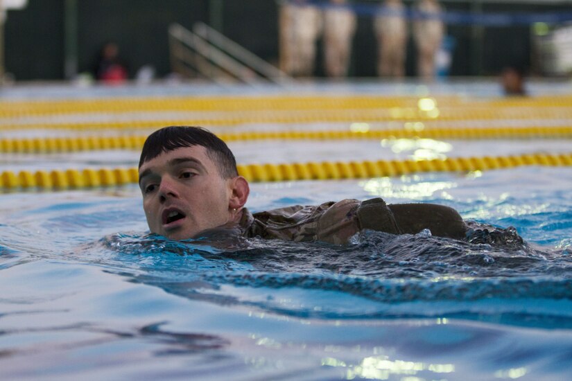 Soldier swimming in a pool.