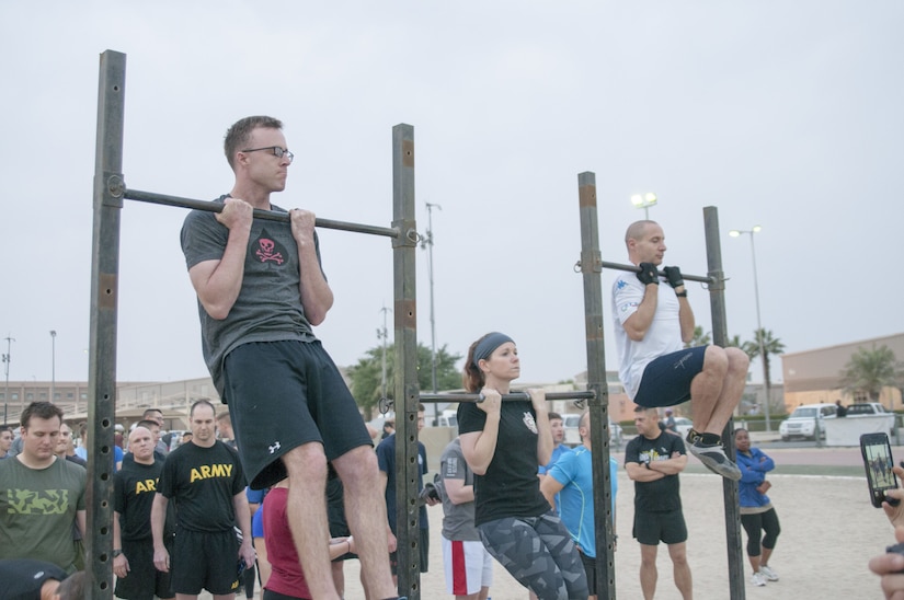 Soldiers doing pull-ups.