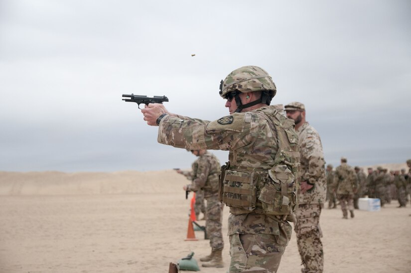 Soldiers firing pistols.