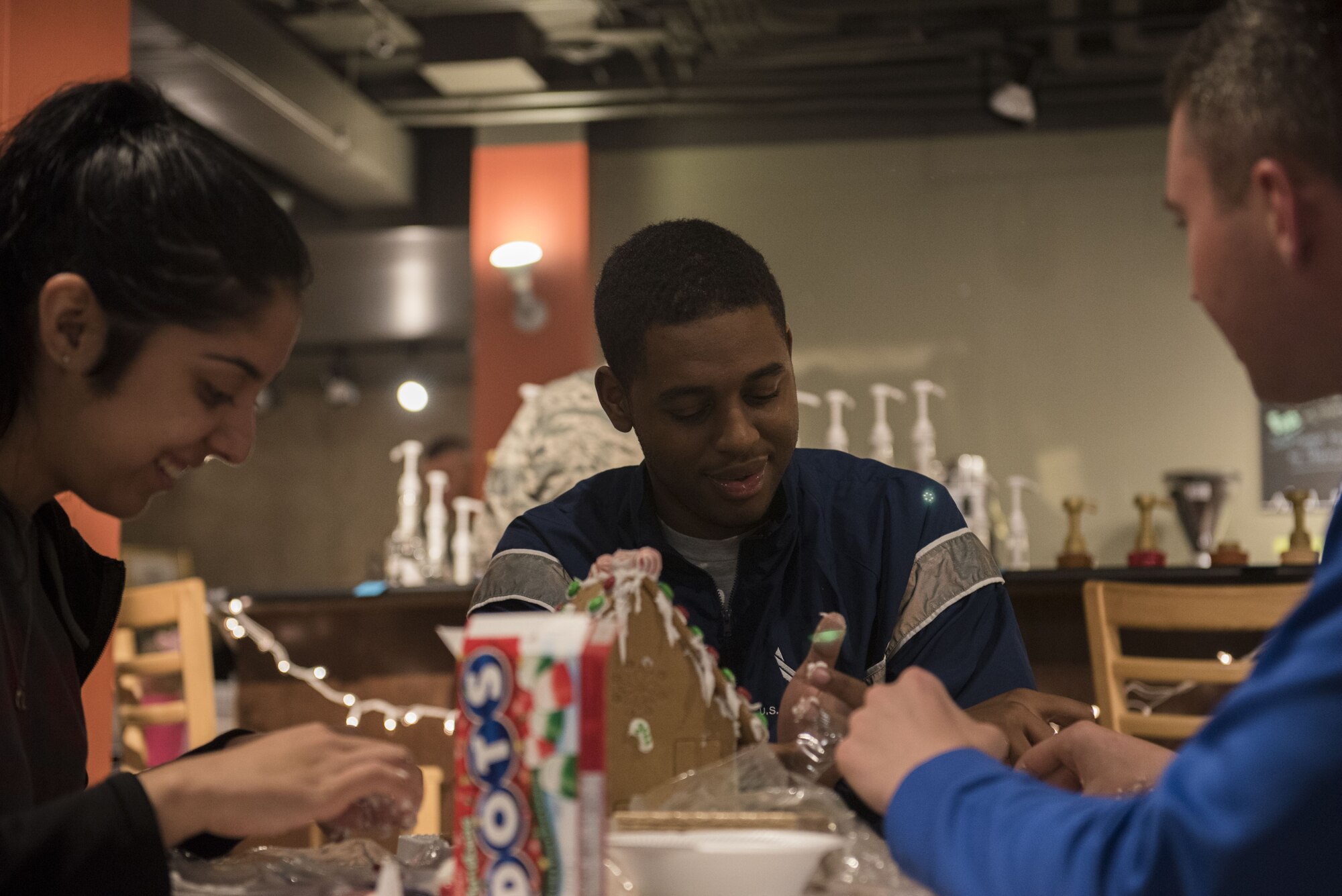 PETERSON AIR FORCE BASE, Colo.— A group of Airmen work diligently on their house in the last ten minutes of the gingerbread competition at the Eclipse Cyber Café on Peterson Air Force Base, Colorado, December 6, 2017. Little did these Airmen know that they would be the winners of this competition. (U.S. Air Force Photo by Airman First Class Alexis Christian)