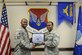 Senior Airman Ramel Hicks, right, 628th Medical Group health services manager and command support staff administrator, receives the Diamond Sharp Award certificate from Tech. Sgt. Robert Niter, left, 628th MDG interim first sergeant, in the 628th MDG conference room at Joint Base Charleston, S.C., Dec. 12, 2017.