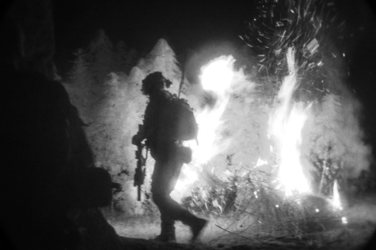 A U.S. Special Forces soldier, attached to Special Operations Task Force-Afghanistan, sets fire to a field of marijuana, found outside of a compound housing a drug lab, during an operation in the Ghorak district, Helmand province, Afghanistan.