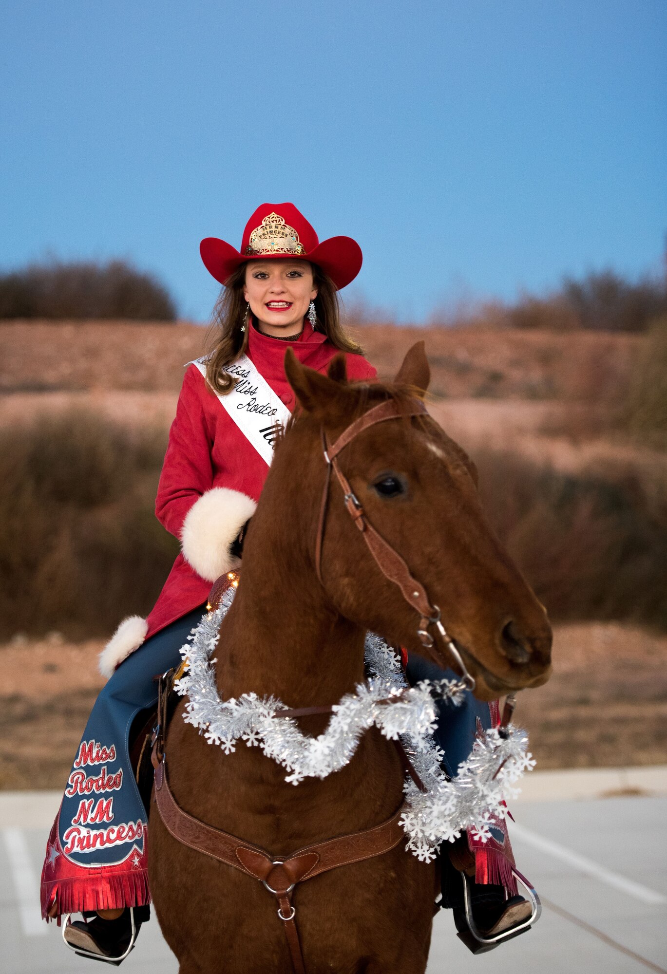 Tylie Garrison, Miss Rodeo New Mexico princess, poses for a photo during the holiday parade and tree lighting ceremony Dec. 7, 2017, at Cannon Air Force Base, New Mexico. The parade included floats decorated by the squadrons and an appearance by Santa Claus himself. (U.S. Air Force photo by Staff Sgt. Michael Washburn/Released)