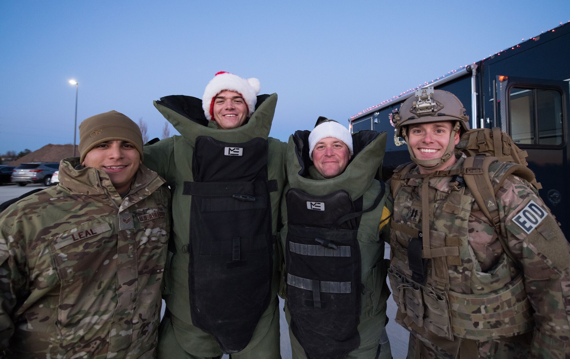 Members from the 27th Civil Engineer Squadron Explosive Ordinance Disposal, pose for a group photo during the holiday parade and tree lighting ceremony Dec. 7, 2017, at Cannon Air Force Base, New Mexico. The parade included floats decorated by the squadrons and an appearance by Santa Claus himself. (U.S. Air Force photo by Staff Sgt. Michael Washburn/Released)