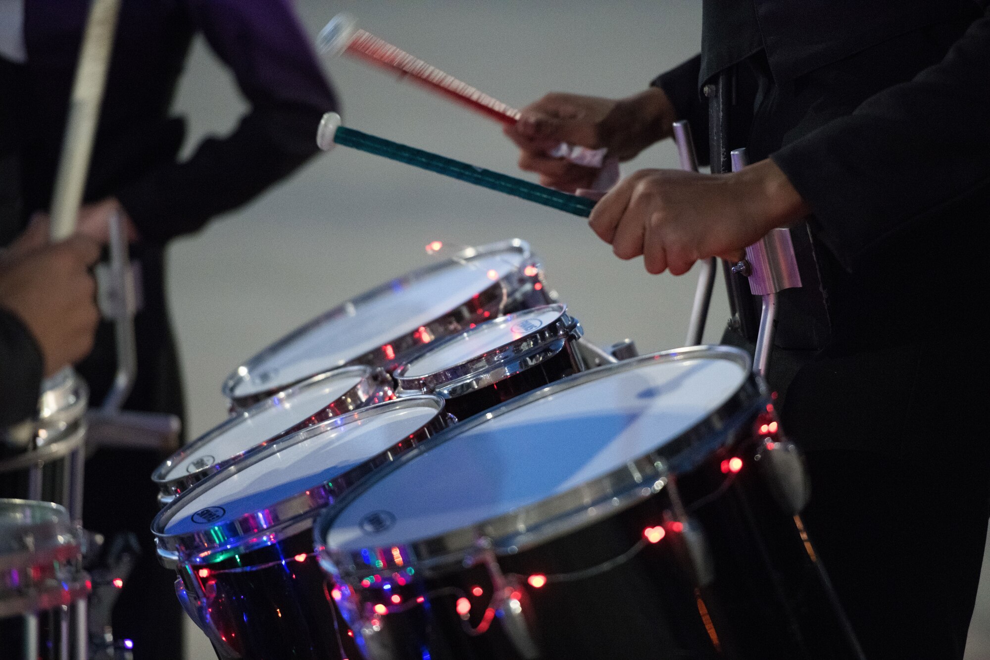 A Clovis High School Marching Band member plays the drums during the holiday parade and tree lighting ceremony Dec. 7, 2017, at Cannon Air Force Base, New Mexico. The dance team and the Clovis High School Marching Band led the parade through base housing, finishing at the Landing Zone. (U.S. Air Force photo by Staff Sgt. Michael Washburn/Released)