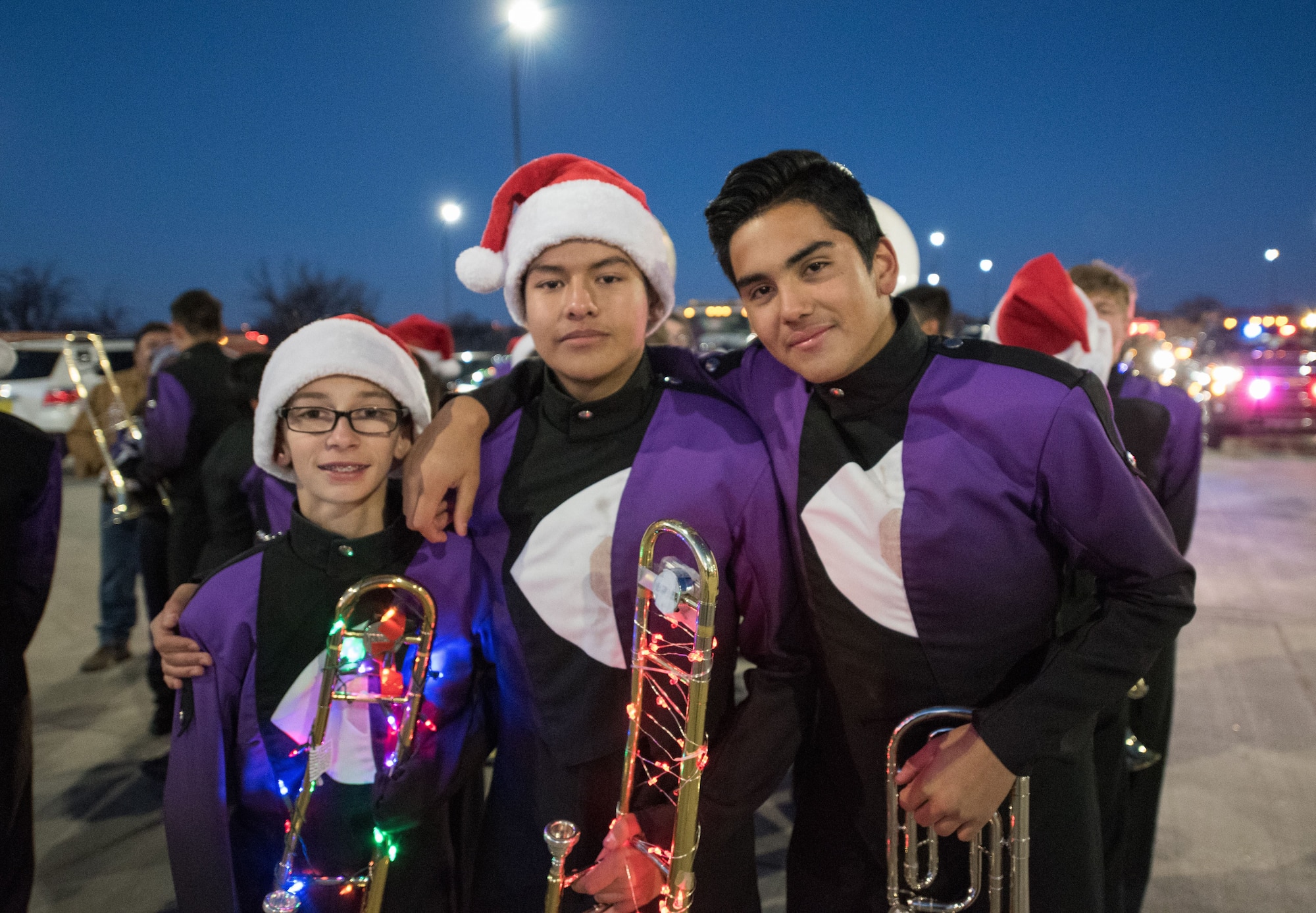Clovis High School Marching Band members pose for a photo during the holiday parade and tree lighting ceremony Dec. 7, 2017, at Cannon Air Force Base, New Mexico. The marching band, along with the Clovis High School Dance Team, led the parade through base housing, finishing at the Landing Zone. (U.S. Air Force photo by Staff Sgt. Michael Washburn/Released)