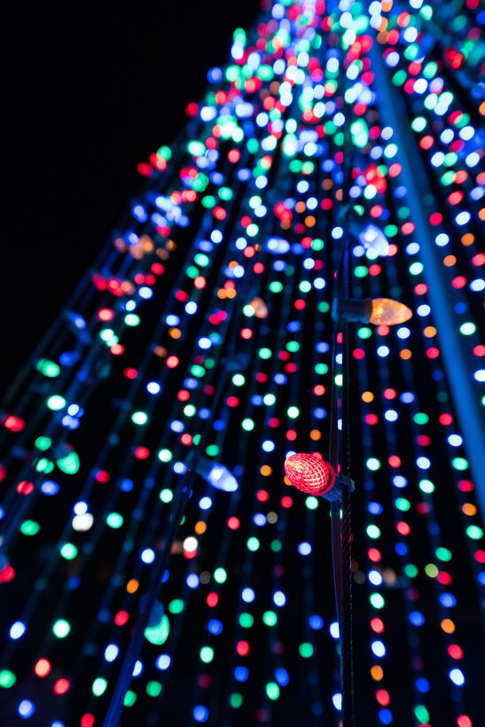 Holiday lights in the style of a tree light up the round-about entrance to the Landing Zone during the holiday parade and tree lighting ceremony Dec. 7, 2017, at Cannon Air Force Base, New Mexico. The parade included floats decorated by the squadrons and an appearance by Santa Claus himself. (U.S. Air Force photo by Staff Sgt. Michael Washburn/Released)