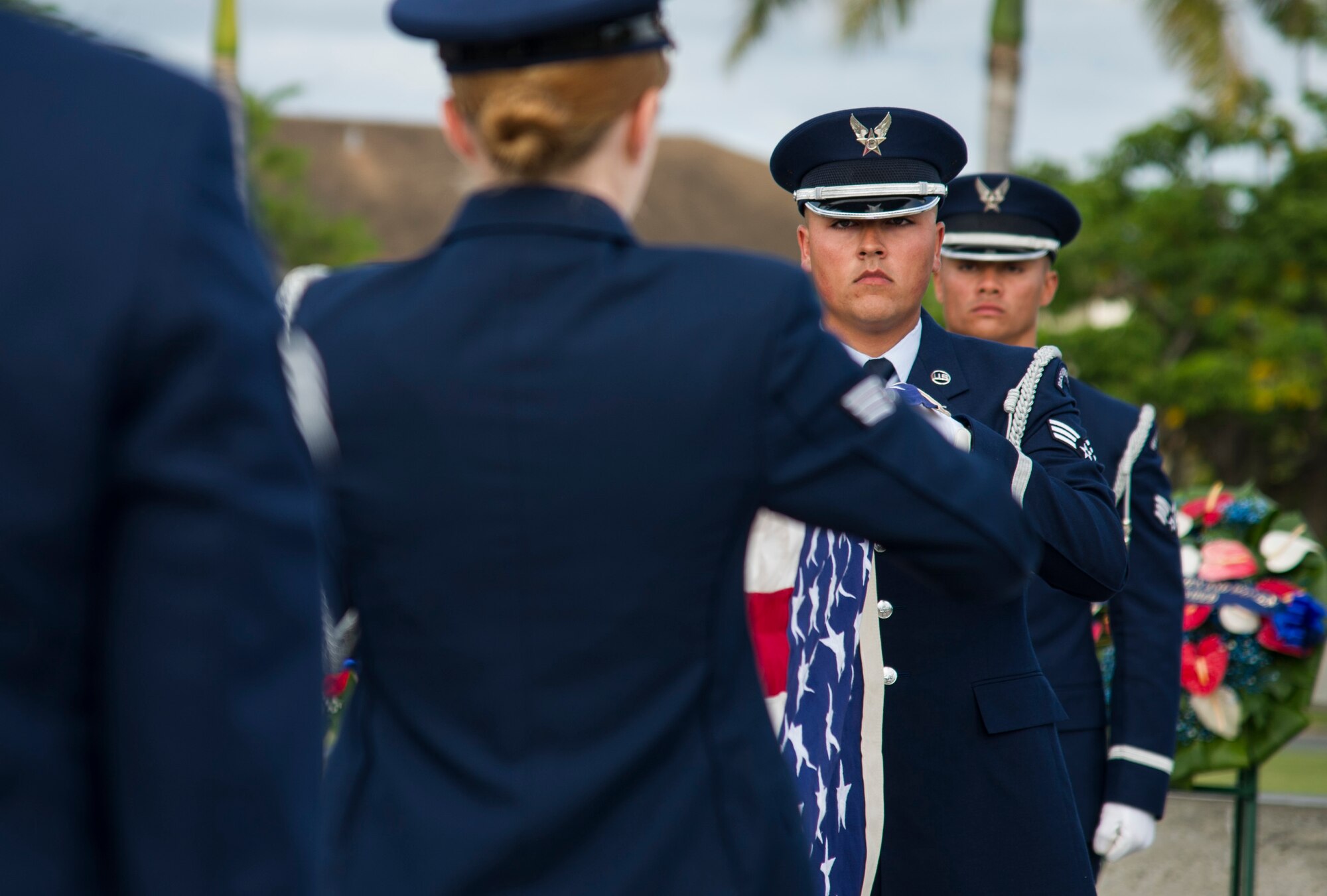 Members of the Hickam Honor Guard fold a U.S. flag.