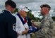 Lt. Col. Walter Sorenson, Joint Base Security commander, presents a U.S. flag to former Tech. Sgt. Durward Swanson.