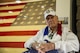 Former Tech. Sgt. Swanson poses for a photo in front of the U.S. flag.