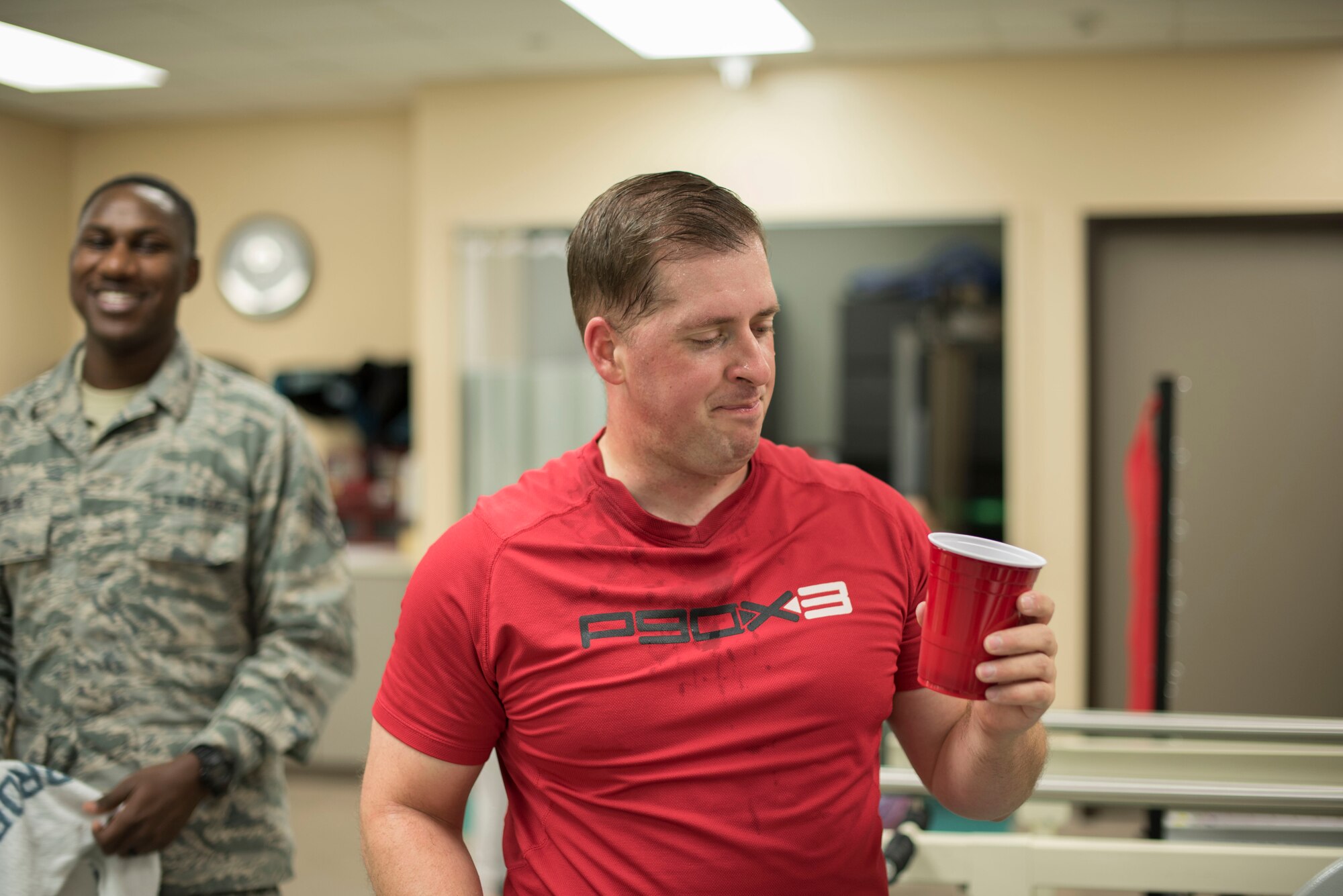 Tech. Sgt. James Hodgman, 60th Air Mobility Wing Public Affairs NCO in charge of command information, hydrates during a training session at the physical therapy clinic inside David Grant USAF Medical Center at Travis Air Force Base, Calif., Nov. 27, 2017. The physical therapy clinic is comprised of dedicated professionals who specialize in providing care for musculoskeletal disorders and movement dysfunction. (U.S. Air Force photo by Airman 1st Class Jonathon D. A. Carnell)
