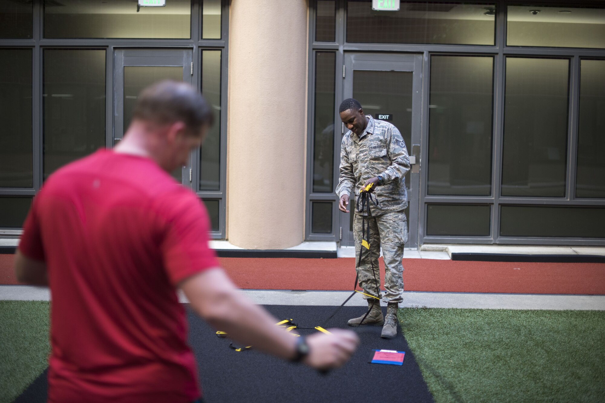 Staff Sgt. Christian J. Taylor, 60th Medical Operations physical medicine technician, changes exercises for Tech. Sgt. James Hodgman, 60th Air Mobility Wing Public Affairs NCO in charge of command information, at the physical therapy clinic inside David Grant USAF Medical Center at Travis Air Force Base, Calif., Nov. 27, 2017. The physical therapy clinic is comprised of dedicated professionals who specialize in providing care for musculoskeletal disorders and movement dysfunction. (U.S. Air Force photo by Airman 1st Class Jonathon D. A. Carnell)