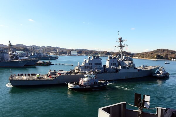171213-N-VA840-005 TOKYO BAY, Japan (Dec. 13, 2017) - The Arleigh Burke-class guided-missile destroyer USS John S. McCain (DDG 56) is towed to the pier at Fleet Activities (FLEACT) Yokosuka. John S. McCain will undergo repairs at Ship Repair Facility – Japan Regional Maintenance Center in Yokosuka.