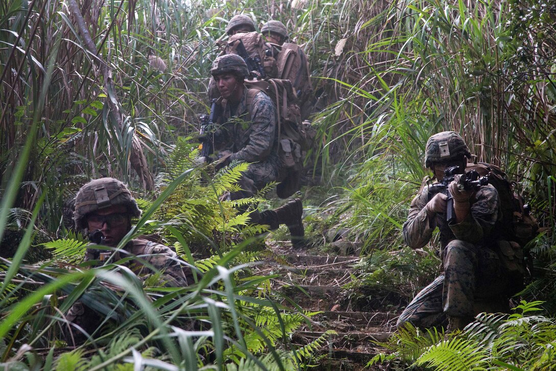 Marines provide security after conducting simulated village raids.