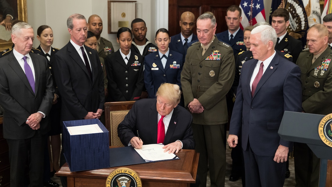 President Donald J. Trump signs a bill.