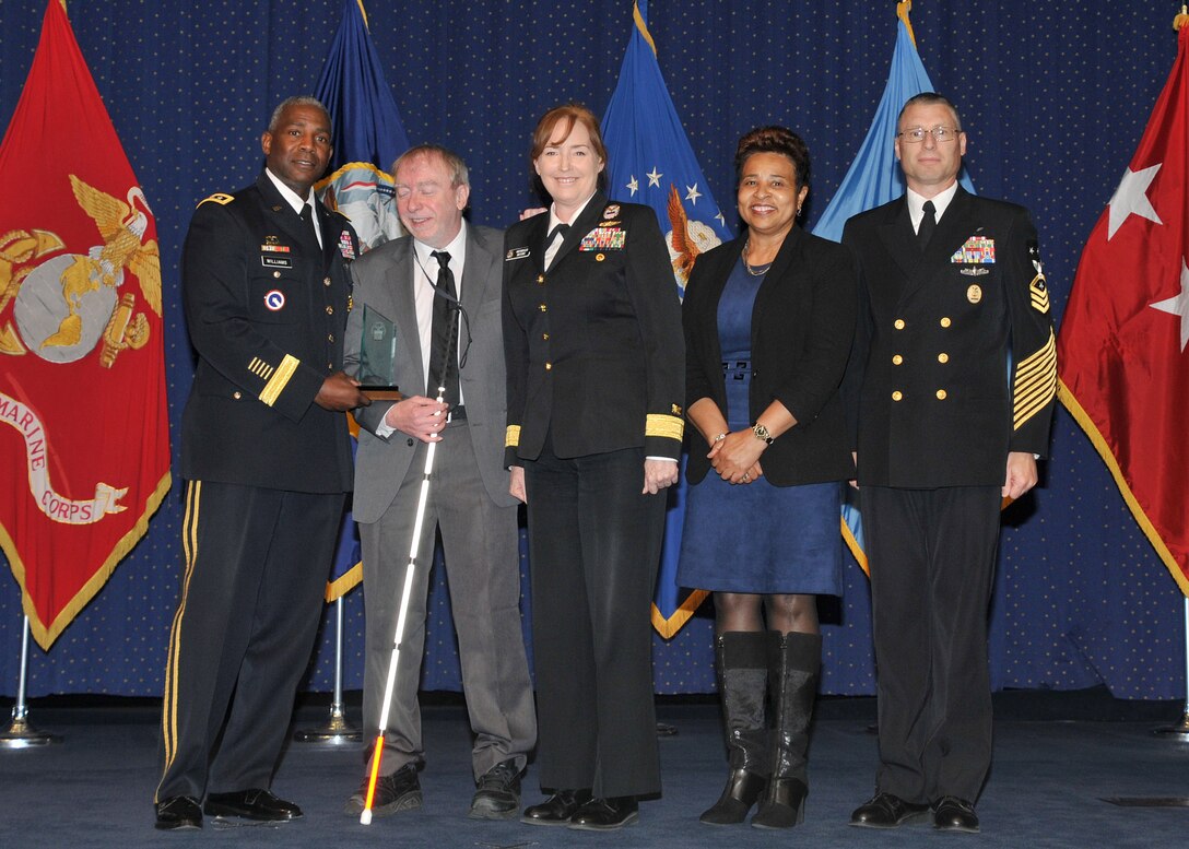 Receiving the Outstanding DLA Employee with Disabilities award was Thomas Comeans (second from left) joined by DLA Director Army Lt. Gen. Darrell Williams; Rear Adm. Michelle Skubic, commander of DLA Land and Maritime; Janice Samuel, acting director of the DLA EEO Office; and Command Master Chief Shaun Brahmsteadt.