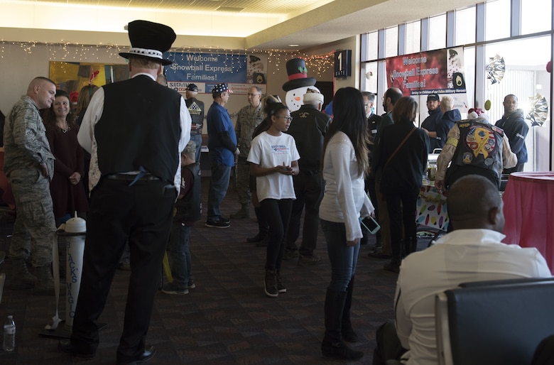 COLORADO SPRINGS AIRPORT, Colo.— Parents and children alike mingle with leadership from surrounding bases at the gate in the Colorado Springs Airport, Colorado, December 9, 2017. Snowball Express invites surrounding military leadership to come speak and interact at events to help remind families that they are not forgotten by their military community. The Snowball express ethos it to create a family, united by shared convictions to remember, honor, inspire and heal. (U.S. Air Force photo by Airman First Class Alexis Christian)