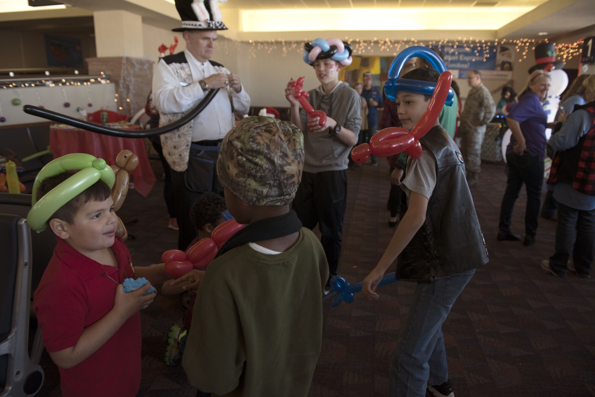 COLORADO SPRINGS AIRPORT, Colo.— Children play with their new ballon creations at the gate in the Colorado Springs Airport, Colorado, December 9, 2017. Falcons and balloon swords were a favorite among the children, sword fights were abundant throughout the party. (U.S. Air Force photo by Airman First Class Alexis Christian)