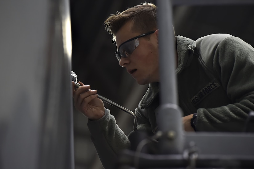 Airman 1st Class Nicolas Rainey, 437th Aircraft Maintenance Squadron aerospace maintenance technician, performs ground maintenance on a C-17 Globemaster III in preparation for a Joint Forcible Entry training event in support of the U.S. Air Force Weapons School Integration phase Dec. 8. Thirty seven C-17s, 21 C-130 Hercules and 120 U.S. Army paratroopers participated in the mobility portion of the WSINT phase during a simulated mass JFE event over a contested target Dec. 9, on a range near Nellis Air Force Base, Nev. The event demonstrates the U.S. Air Force’s ability to execute rapid, decisive responses to crises worldwide.