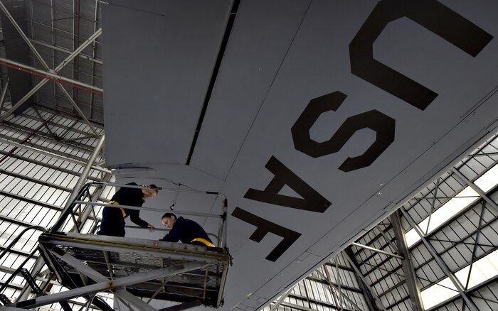 Tech Sgt. Chris Kalif, left, and Staff Sgt. Erin Winkler, right, both 437th Aircraft Maintenance Squadron aerospace maintenance craftsmen, perform ground maintenance on a C-17 Globemaster III in preparation for a Joint Forcible Entry training event in support of the U.S. Air Force Weapons School Integration phase Dec. 8. Thirty seven C-17s, 21 C-130 Hercules and 120 U.S. Army paratroopers participated in the mobility portion of the WSINT phase during a simulated mass JFE event over a contested target Dec. 9, on a range near Nellis Air Force Base, Nev. The event demonstrates the U.S. Air Force’s ability to execute rapid, decisive responses to crises worldwide.