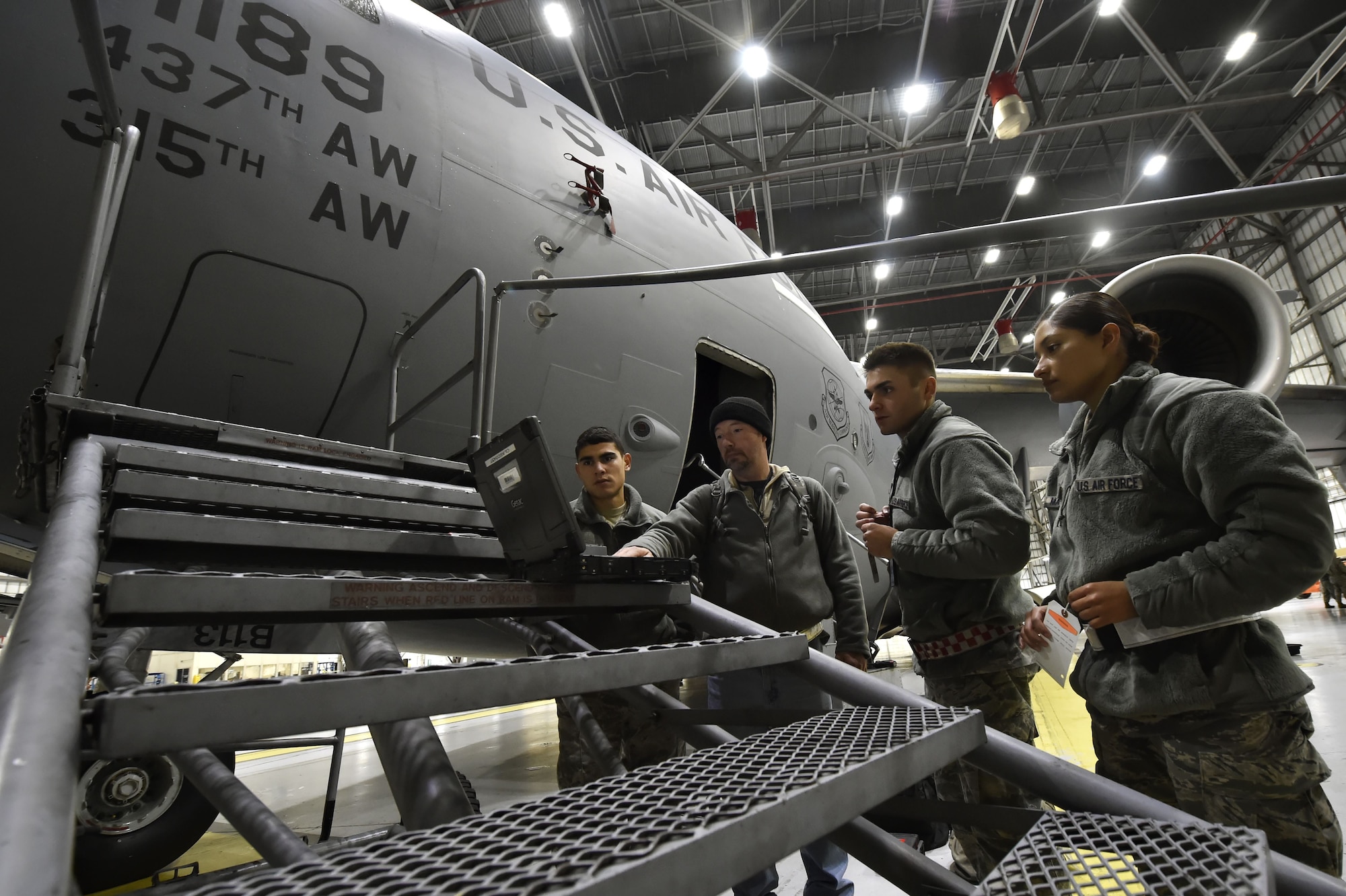 Members of the 437th Aircraft Maintenance Squadron perform ground maintenance on a C-17 Globemaster in preparation for a Joint Forcible Entry training event in support of the U.S. Air Force Weapons School Integration phase Dec. 8. Thirty seven C-17s, 21 C-130 Hercules and 120 U.S. Army paratroopers participated in the mobility portion of the WSINT phase during a simulated mass JFE event over a contested target Dec. 9, on a range near Nellis Air Force Base, Nev. The event demonstrates the U.S. Air Force’s ability to execute rapid, decisive responses to crises worldwide.