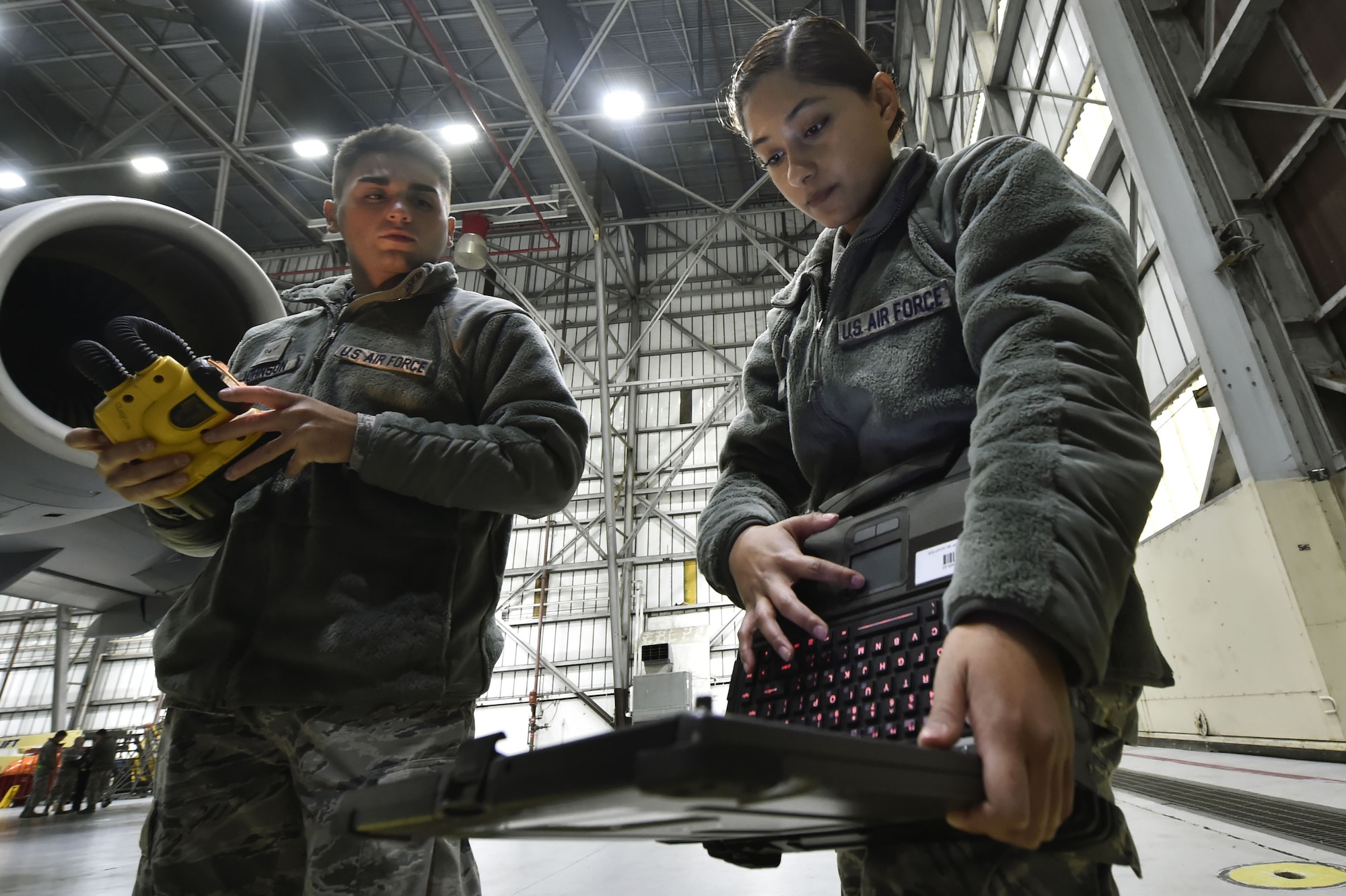 Airman 1st Class Richard Johnson, left, and Airman 1st Class Yasuary Martinez, both 437th Aircraft Maintenance Squadron aerospace maintenance journeymen, perform ground maintenance on a C-17 Globemaster III in preparation for a Joint Forcible Entry training event in support of the U.S. Air Force Weapons School Integration phase Dec. 8. Thirty seven C-17s, 21 C-130 Hercules and 120 U.S. Army paratroopers participated in the mobility portion of the WSINT phase during a simulated mass JFE event over a contested target Dec. 9, on a range near Nellis Air Force Base, Nev. The event demonstrates the U.S. Air Force’s ability to execute rapid, decisive responses to crises worldwide.