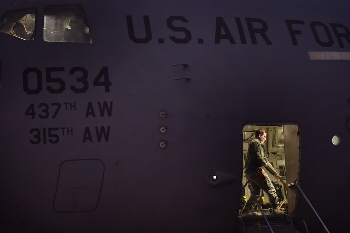 Staff Sgt. Tyler Switzer, 437th Aircraft Maintenance Squadron aerospace maintenance craftsman, prepares a C-17 Globemaster III for a Joint Forcible Entry training event in support of the U.S. Air Force Weapons School Integration phase here, Dec. 9. Thirty seven C-17s, 21 C-130 Hercules and 120 U.S. Army paratroopers participated in the mobility portion of the WSINT phase during a simulated mass JFE event over a contested target on a range near Nellis Air Force Base, Nev. The event is designed to teach Airmen how to get safely to their target and direct airpower and follow-on forces to that target.