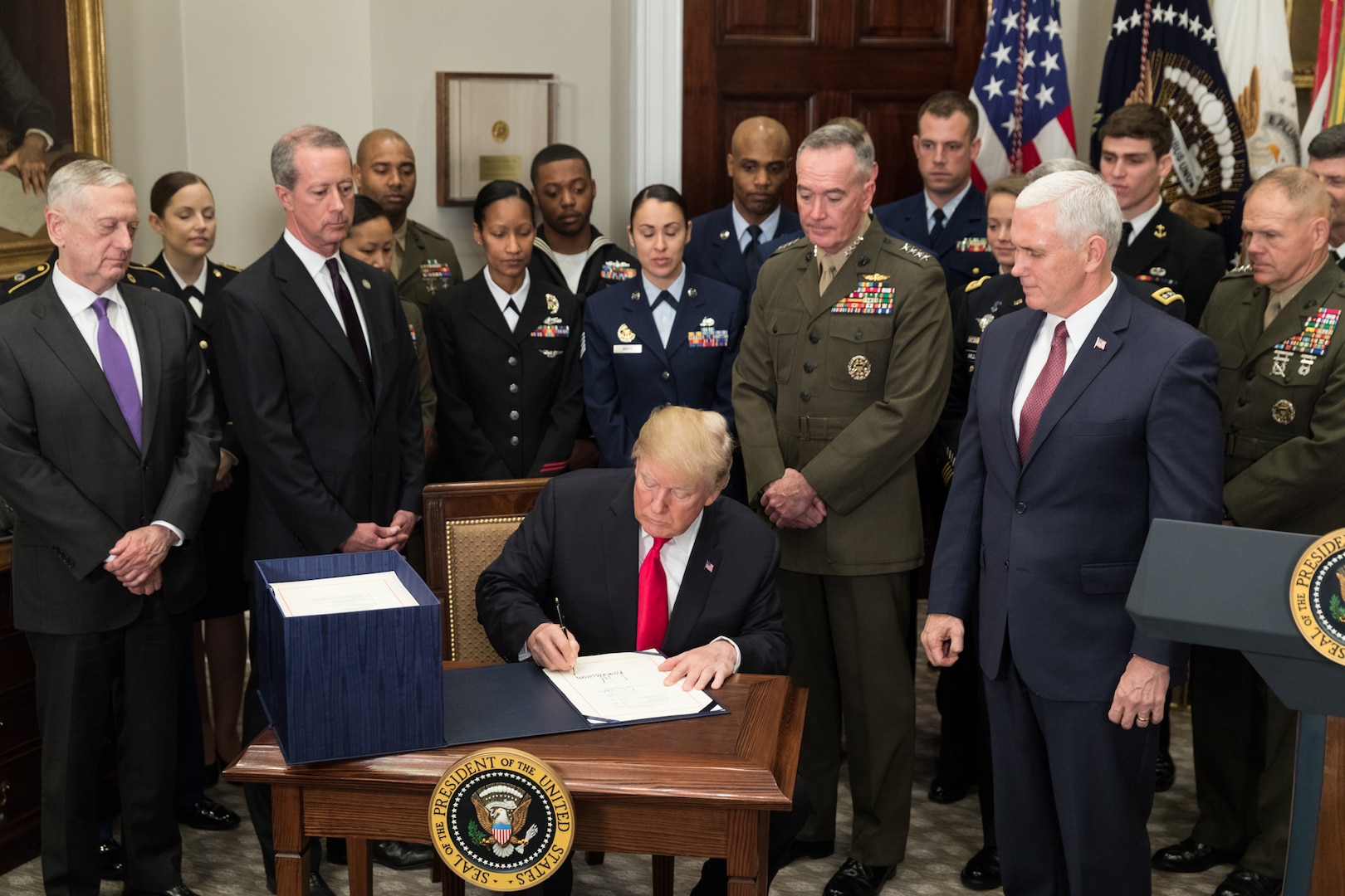 President Donald J. Trump, joined by Vice President Mike Pence and senior military leaders, signs H.R. 2810, the National Defense Authorization Act for fiscal year 2018, in the Roosevelt Room at the White House, Dec. 12, 2017.